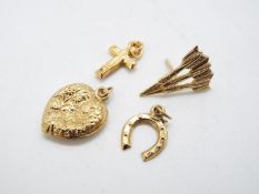 A 9ct gold horseshoe charm, a 9ct gold crucifix pendant,