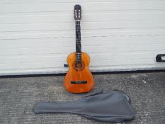 An Admira Clasico acoustic guitar and bag.