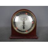 An unusual Year-Going Day Dial Calendar mantel clock in an arched mahogany case,