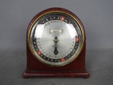 An unusual Year-Going Day Dial Calendar mantel clock in an arched mahogany case,