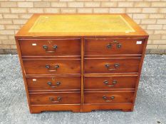 A chest of drawers with leather insert to the top, approximately 74 cm x 94 cm x 64 cm.