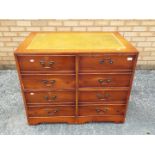 A chest of drawers with leather insert to the top, approximately 74 cm x 94 cm x 64 cm.