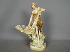 Royal Dux - A large centrepiece modelled as a female fisher woman drawing a net aside a shell