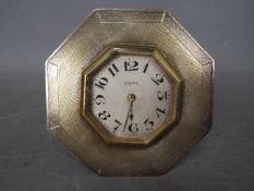 An Edward VII desk clock with octagonal, hallmarked silver surround with engine turned decoration,