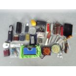 A mixed lot of collectables to include penknives, vintage cigarette lighters,