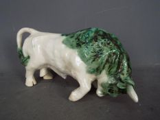 A Paula Humphries Polperro studio pottery figurine depciting a bull,