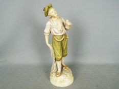 A large Royal Dux figurine depicting a standing fisher man holding a pipe and net,