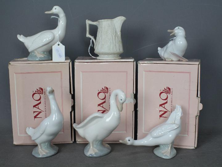 Nao - Three boxed figurines of ducks, two unboxed and a Portmeirion Parian jug.