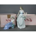 Nao - Two boxed figurines comprising Listening To Bird Song #1042 and Playing With The Wind # 1343,