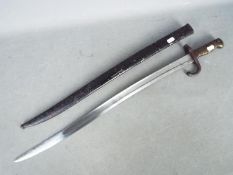 A french chassepot 1869 pattern sworn bayonet with brass handle dated 1869 and marked to the blade