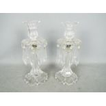 A pair of clear glass lustres, the tops in the form of flower heads, approximately 29 cm (h).