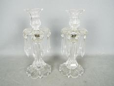 A pair of clear glass lustres, the tops in the form of flower heads, approximately 29 cm (h).