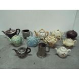 Tea Pot Collector - Left to right in rows description = Elkington art deco metal wood handle,