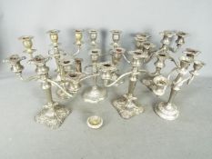 A collection of plated candelabrum.