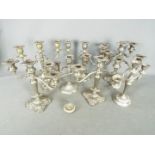 A collection of plated candelabrum.