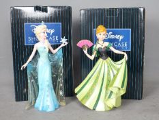 Two Disney Showcase Collection figurines comprising Anna and Elsa from Frozen,