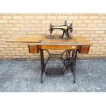 A Singer sewing machine table with fold away machine,