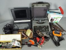 A mixed lot to include vintage hand tools, boxed security light, portable typewriter,