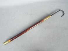 A decorative, vintage fishing gaff with brass ferrule,