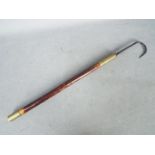 A decorative, vintage fishing gaff with brass ferrule,