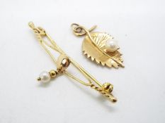 A 9ct gold pendant in the form of a leaf and a 9ct gold bar brooch, approximately 3.6 grams all in.