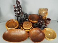 Treen to include bowls, tribal carvings, lidded box and similar.