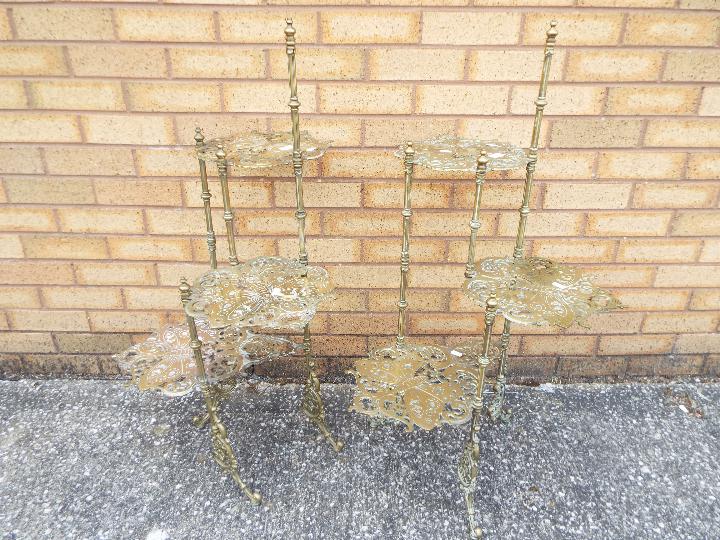 A pair of brass, three tier, cake stands with cast butterfly decoration, approximately 97 cm (h).