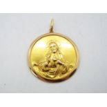 An 18ct gold religious pendant with image of Jesus of Nazareth, suspension loop stamped Fabor 750,