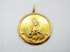 An 18ct gold religious pendant with image of Jesus of Nazareth, suspension loop stamped Fabor 750,