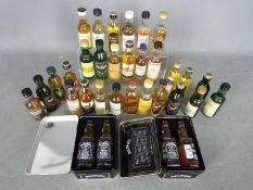 A collection of 33 whisky / whiskey miniatures comprising Tamnavulin 12 y/o, Bruichladdich 10 y/o,