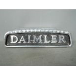 Automobilia - A cast aluminium Daimler bus badge, approximately 10.5 cm x 38 cm.