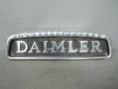 Automobilia - A cast aluminium Daimler bus badge, approximately 10.5 cm x 38 cm.