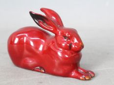 Royal Doulton - A small flambe rabbit, recumbent,