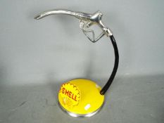 A Shell petrol pump handle,