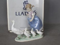Lladro - A boxed figural group entitled Hurry Now, # 5503, depicting a young girl driving geese,