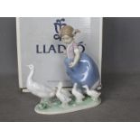 Lladro - A boxed figural group entitled Hurry Now, # 5503, depicting a young girl driving geese,