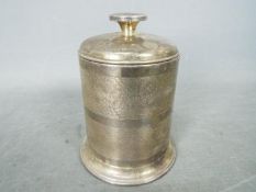A George VI hallmarked silver cigarette box of cylindrical form,