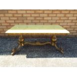 A rectangular marble topped table on brass supports,
