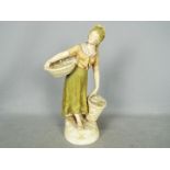 A large Royal Dux figurine of a fisher woman carrying two baskets,