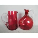 A Cranberry Glass jug decorated with twisted handles,
