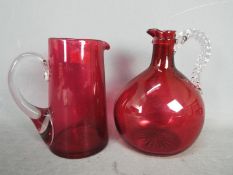 A Cranberry Glass jug decorated with twisted handles,