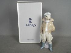 Lladro - A boxed figurine entitled Little Pilot, # 6451, depicting a young boy in flight gear,