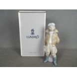 Lladro - A boxed figurine entitled Little Pilot, # 6451, depicting a young boy in flight gear,