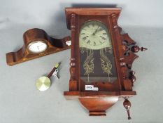 A mantel clock with inlaid decoration and a modern wall clock.