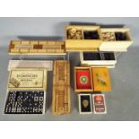 Lot to include vintage dominoes, playing cards, cribbage boards, chess pieces.