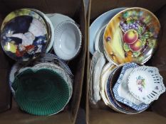 Two boxes of mixed ceramics, predominantly plates.