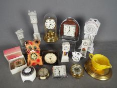 An interesting collection of 9 small clocks to include wall and mantel and alarm models together