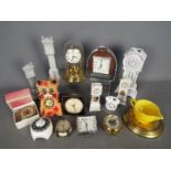 An interesting collection of 9 small clocks to include wall and mantel and alarm models together