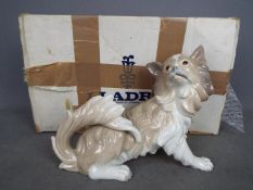 Lladro - A boxed figurine depicting a dog, entitled Perro Papillon, model # 01004857,
