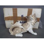 Lladro - A boxed figurine depicting a dog, entitled Perro Papillon, model # 01004857,